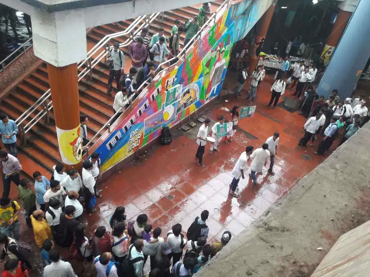 Street theatre artists performing for a large audience in India